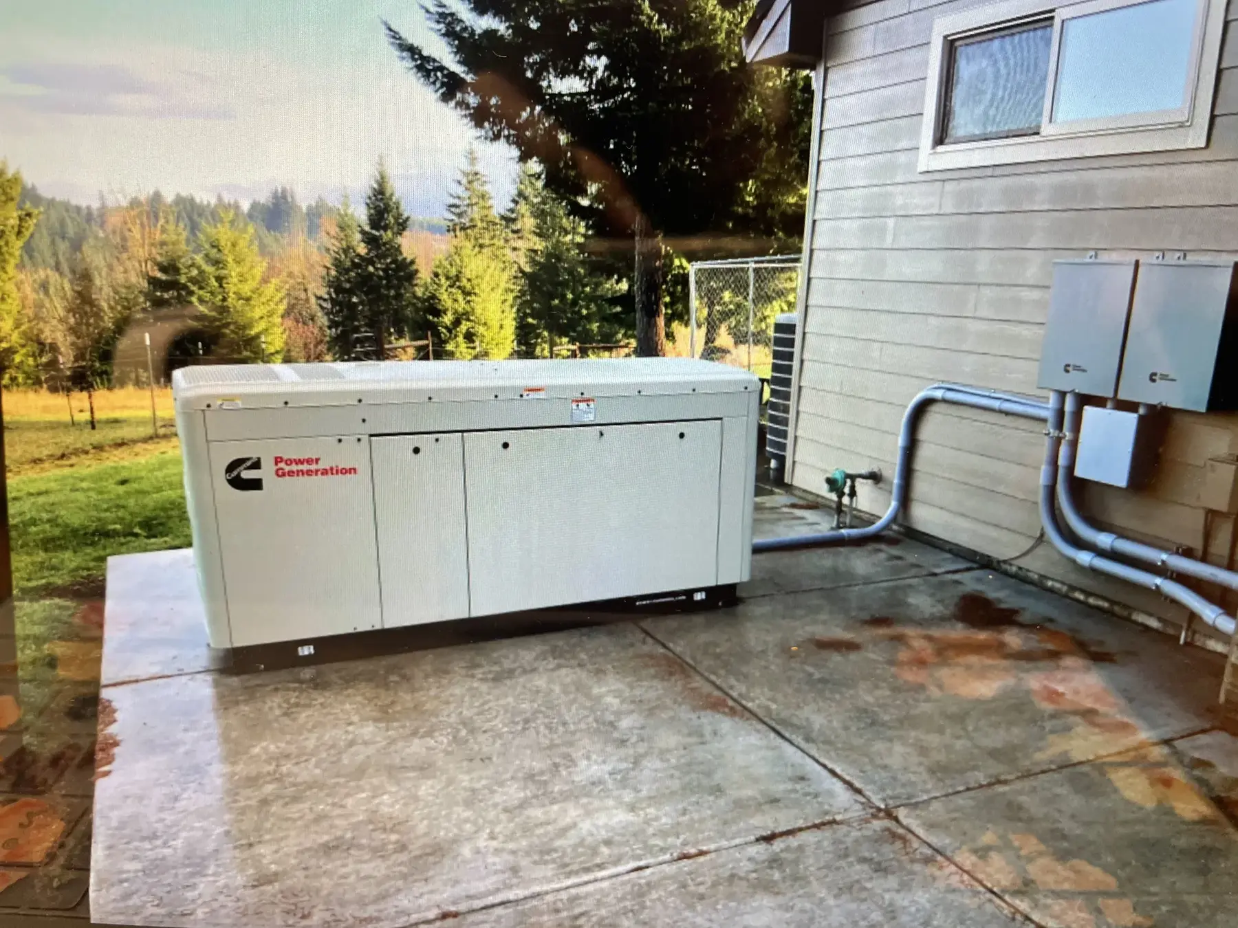 Standby generator beside a finished patio