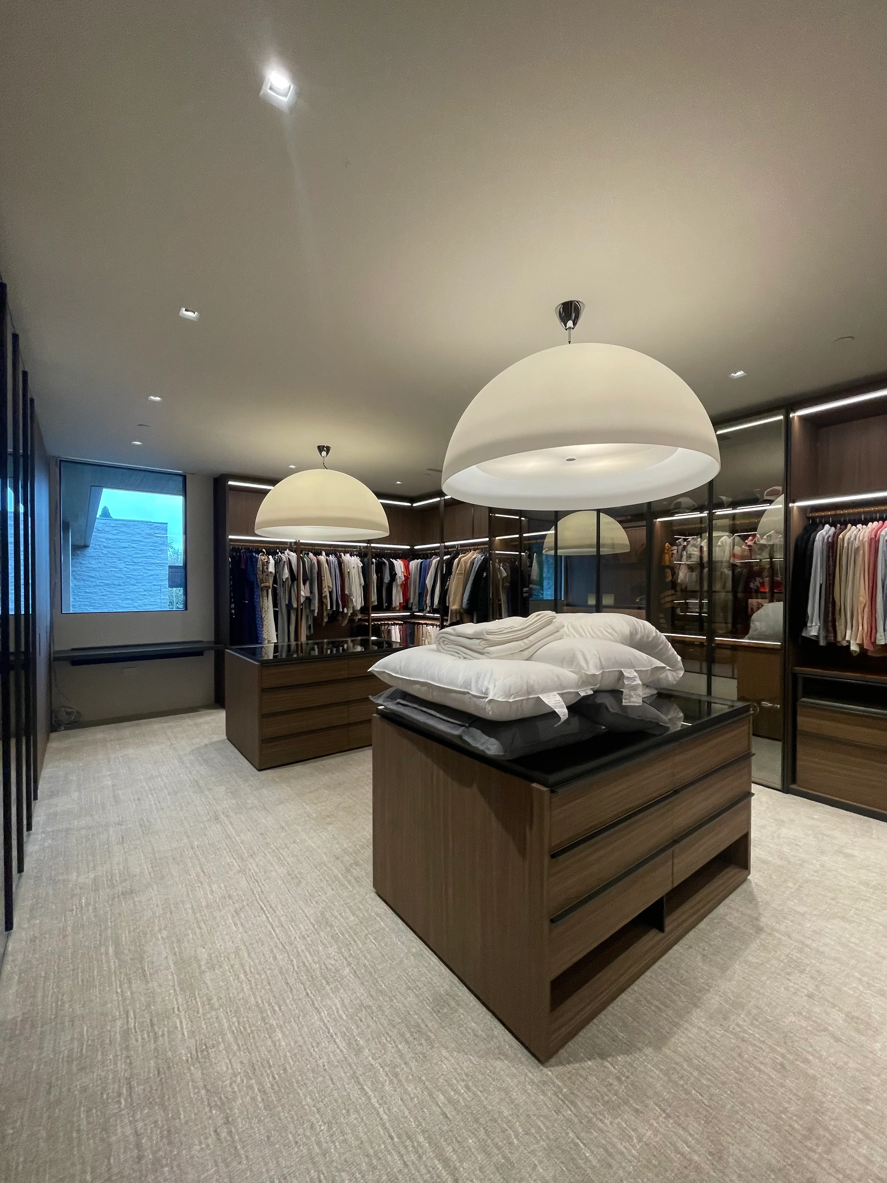 Globe pendant lighting in a finished walk-in closet