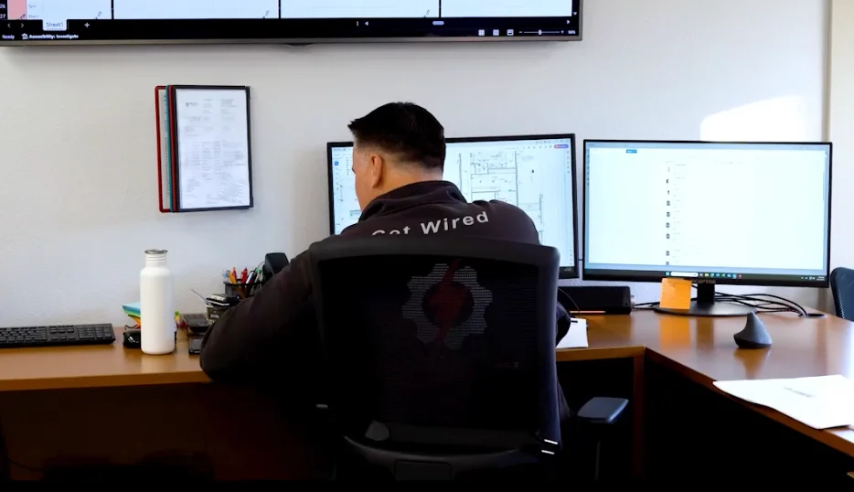 Pro Tech Power team member coordinating electrical plans in the company office